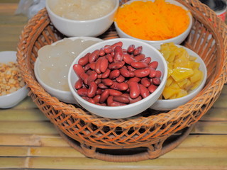 Close up sweet red beans in white bowl with Thai dessert background.