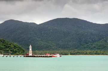 Turquoise tropical sea, white lighthouse, fishing boats, Bang Bao pier and tropical Koh Chang...