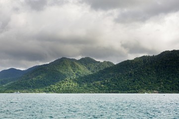 Tropical sea, monsoon storm heavy clouds and tropical Koh Chang island on horizon in Thailand