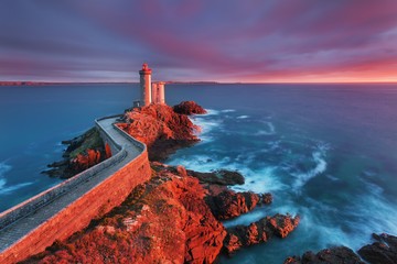 View of Lighthouse the Phare du petit minou in Plouzane, at sunset with red light , Brest , France,...