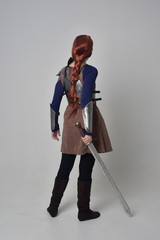 full length portrait of a  red haired girl wearing medieval warrior costume and steel armour,...