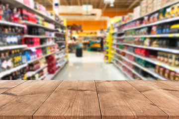 Empty wood table top on shelf in supermarket blurred background