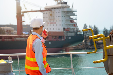 harbor master port control in command the ship to takes berthing to alongside the port for...