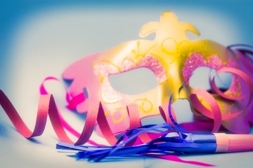 carnival masks and blowers with blue background