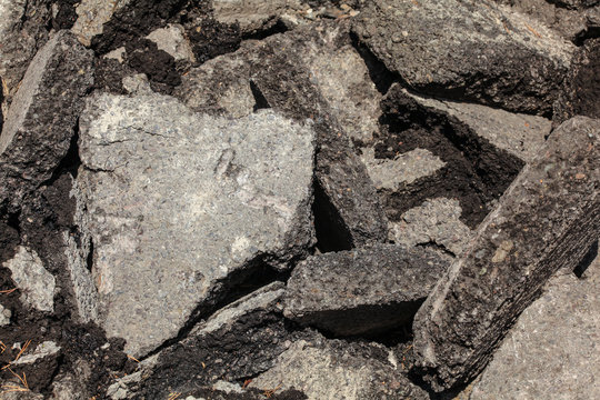 Discarded asphalt / concrete. Broken pieces laying on the sun.