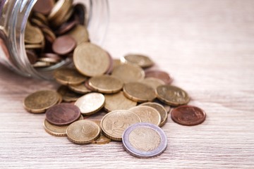 glass jar with coins, saving concept