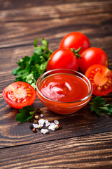 Tomato ketchup sauce on wooden background