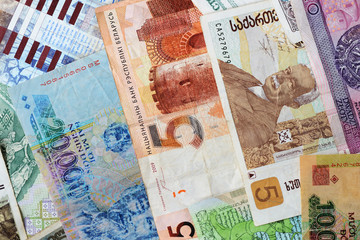 Different countries money background close up. Belarusian rubles, Georgian lari, Polish zloty, Israeli shekels, Vietnamese dongs