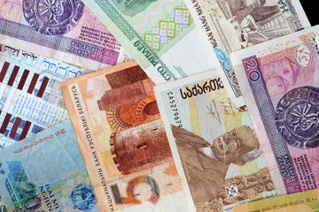 Different countries money background close up. Belarusian rubles, Georgian lari, Polish zloty,...