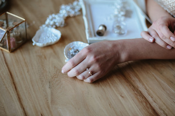 Closeup macro photo of details, workplace of decorator and creator of wedding imitation jewelry. Woman's hands in a process of creation