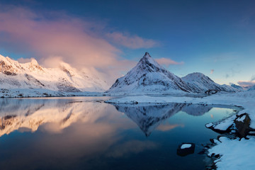 Fototapeta na wymiar Panoramic landscape, winter mountains and fjord reflection in water. Norway, the Lofoten Islands. Colorful winter sunset or sunrise above the arctic circle. Christmas time concept