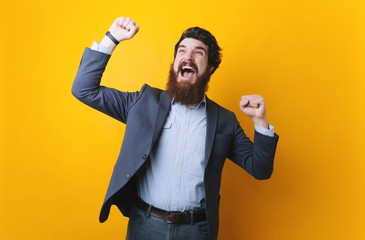Photo of happy businessman, stylish bearded man make winner gesture.