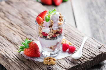 Delicious home-made muesli with yoghurt and fresh berries, beautifully presented in a mason jar to take away on the go