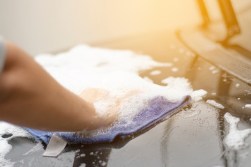 Close up human hand washing car