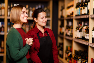 Image on side of two happy women in store on background of shelves