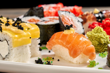 Close up of cheese rolls and sake nigiri.