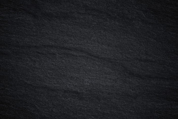 Dark grey black slate background or natural stone texture.