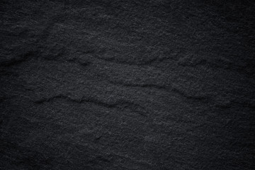 Dark grey black slate background or natural stone texture.