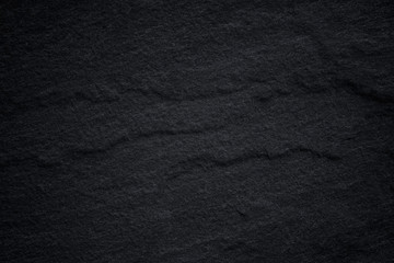 Dark grey black slate background or natural stone texture.