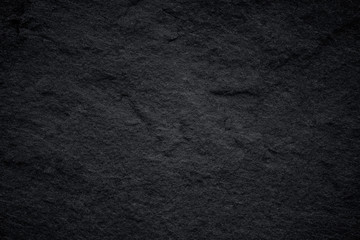 Dark grey black slate background or natural stone texture.