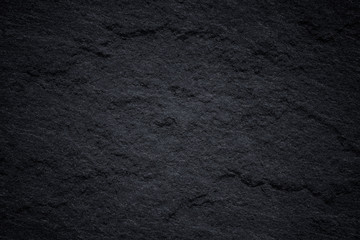 Dark grey black slate background or natural stone texture.