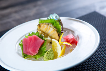 Asian cuisine, sushi, ice cubes, shrimp, salmon, close-up, mint leaves. Fish and meat