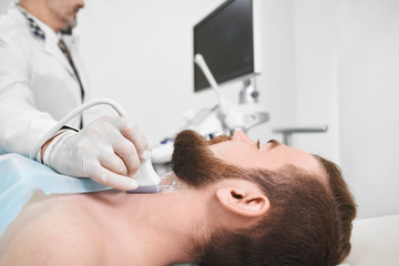 Obraz na płótnie Canvas Doctor using ultrasound probe for lymph node diagnosis.