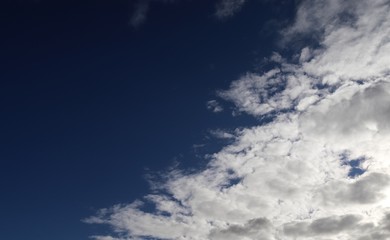Beautiful white fluffy clouds on a deep blue sky