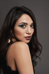 Obraz premium Piękna, elegancka brunetka o długich, czarnych włosach.