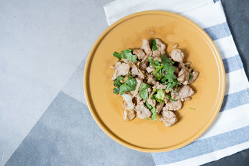 Stir-fried pork with garlic put in a yellow dish