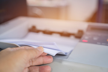 Business office Concept : Hand Businessman is process of press paper on laser print cartridge, lay...