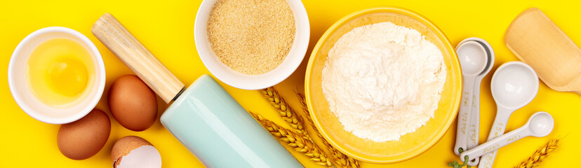 Baking or cooking ingredients on yellow background, flat lay