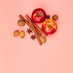 Apples and spices on pink background, flat lay