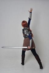 full length portrait of a  red haired girl wearing medieval warrior costume and steel armour,...