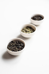 the white drinking bowls of chinese tea in order  on white background