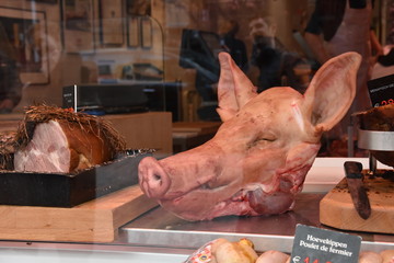 Pig's head in shop window of butchery.