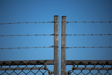 Barbed wired fence providing security to farmland in rural Hampshire