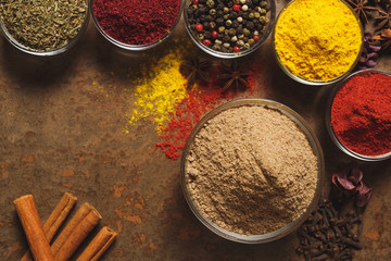 Ground Cumin . Place for text. Different types of Spices in a bowl on a stone background. The view...