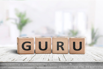 Guru sign on a wooden table in a bright room