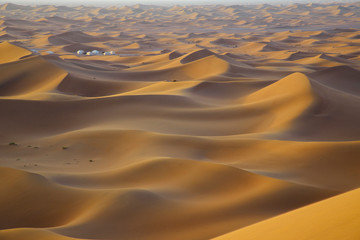 Fototapeta na wymiar White tents in sandy desert