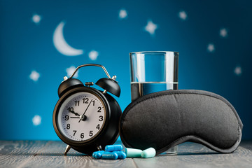 Clock, pills, earplugs, mask