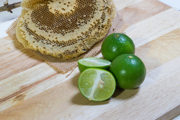 lemon slice and honey on table,