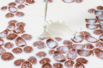 Brown conflakes in strawbery milk, white milk splash,