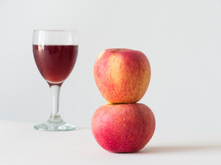 Red apple on wine in glass background,