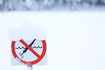 diving sign is prohibited against the background of the winter landscape