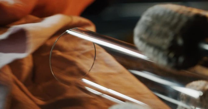 Slow motion macro of glass blower working with flame on a handmade art piece of glass from precious crystal in a workshop. Shot in 8K. Concept of handmade,quality,artisan, made in Italy, glass blower