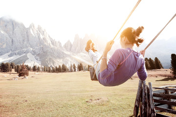 Girls ride on a swing