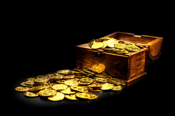 Stacking Gold Coin in treasure chest  on black background