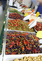 shop with olives and peppers with the movement of the people
