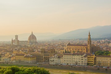 Fototapeta na wymiar View of the Cathedral of Santa Maria del Fiore (Duomo) and Basilica of Santa Croce (Holy Cross). Amazing evening golden hour light. Beautiful gold sunset in Florence, Italy.